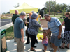 Spectators gather around yellow event tent