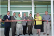 Board members prepare for the ribbon cutting