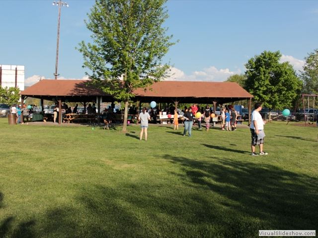 People Standing Outside Park Shelter Holding Balloons 1