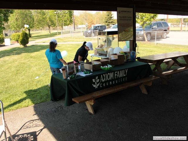 Women Setting Up Axiom Family Counseling Table