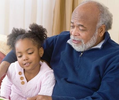 Older Man Reading with Young Girl